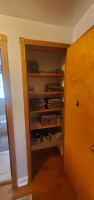 a room with a closet with a door and a shelf at Cottage in the Woods in Washington