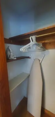 a closet with a shelf and a white lamp at Cottage in the Woods in Washington