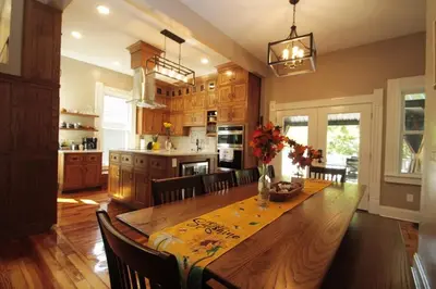 a large kitchen with a wooden table and chairs at 1880s Georgetown Jewel in Georgetown
