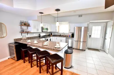a kitchen with a large island with bar stools at Large 4 bedroom Tremont House - Bonus apartment included! in Cleveland