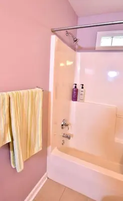 a bathroom with a bath tub and a sink at Large 4 bedroom Tremont House - Bonus apartment included! in Cleveland