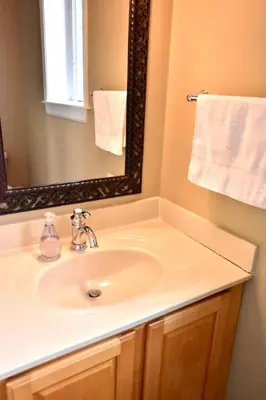 a bathroom with a sink and a mirror and towels at Large 4 bedroom Tremont House - Bonus apartment included! in Cleveland