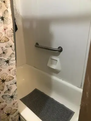 a bathroom with a bath tub with a rug at Suite Serenity in Cleveland