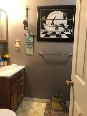 a bathroom with a picture of a sink and a toilet at Suite Serenity in Cleveland