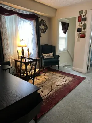 a living room with a chair and a table at Suite Serenity in Cleveland