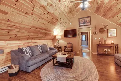 a living room with a couch and a table at Hot Tub Haven 10 Mi to Hocking Hills State Park! in Amanda