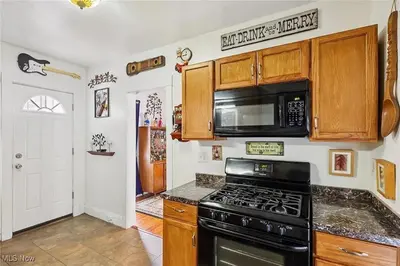 a kitchen with a stove and a microwave at The Boulevard Stay in Cleveland