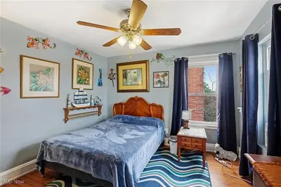 a bedroom with a bed and a ceiling fan at The Boulevard Stay in Cleveland