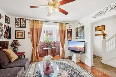 a living room with a couch and a tv at The Boulevard Stay in Cleveland