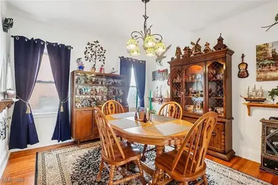 a dining room with a wooden table and chairs at The Boulevard Stay in Cleveland