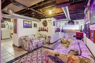 a living room with couches and a flat screen tv at The Boulevard Stay in Cleveland