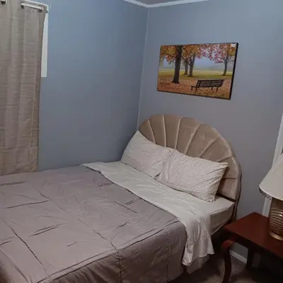 a bedroom with a bed and a picture of a park at The Unique Spot in Cleveland