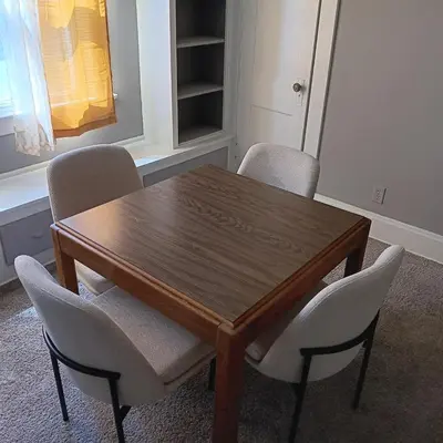 a dining room table with chairs and a wooden table at The Unique Spot in Cleveland