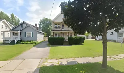 a house with a tree in the front yard at The Unique Spot in Cleveland