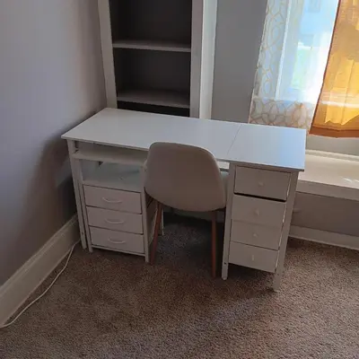 a white desk and a chair in a room at The Unique Spot in Cleveland