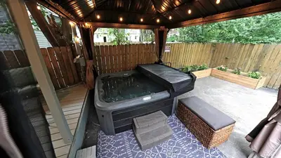 a screened in porch with a grill and a bench at Cozy escape with Hot Tub, ideal for family & friends in Columbus