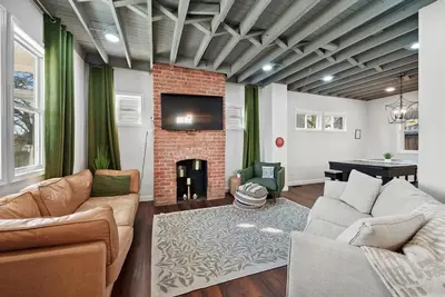 a living room with a couch and a fireplace at Cozy escape with Hot Tub, ideal for family & friends in Columbus