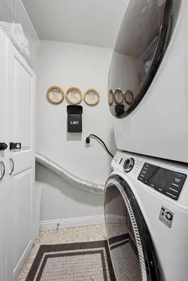 a washer and dryer in a room at Cozy escape with Hot Tub, ideal for family & friends in Columbus