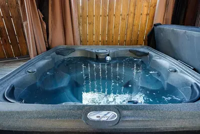 a jacuzzi tub with water in it at Cozy escape with Hot Tub, ideal for family & friends in Columbus