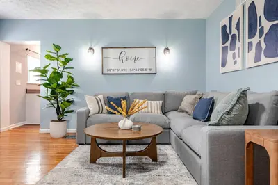 a living room with a gray couch and a table at 5BR/3BA*Game Room*FirePit*Theater*3 mins to ARK! in Williamstown
