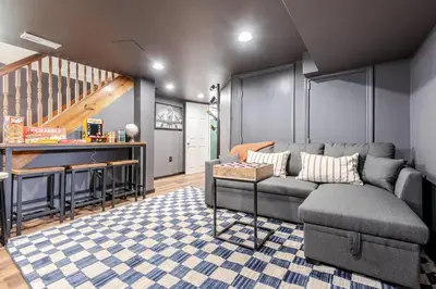 a living room with a couch and a bar at 5BR/3BA*Game Room*FirePit*Theater*3 mins to ARK! in Williamstown