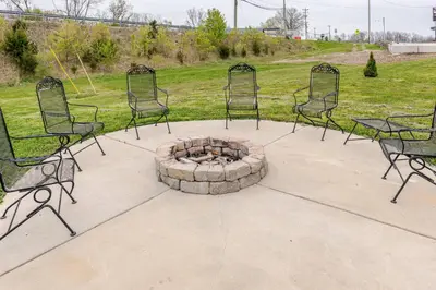 a group of chairs sitting around a fire pit at 5BR/3BA*Game Room*FirePit*Theater*3 mins to ARK! in Williamstown