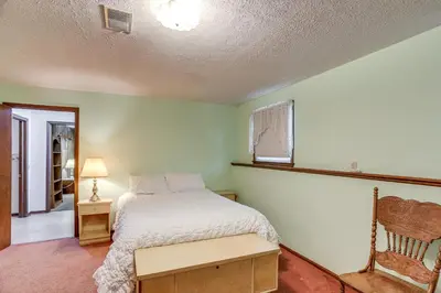 a bedroom with a bed and a chair at Fish, Unplug and Unwind! Countryside Plymouth Home