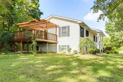 a house with a deck and a yard at Fish, Unplug and Unwind! Countryside Plymouth Home