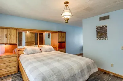 a bedroom with a large bed and a light fixture at Fish, Unplug and Unwind! Countryside Plymouth Home