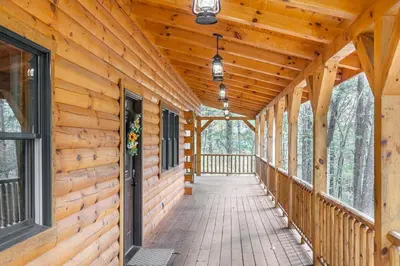 a walkway in a log cabin with windows at Cheerful Cabin Nestled in Serene Wooded Ravine in Logan