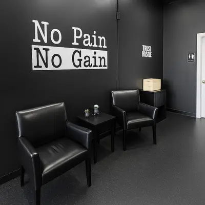 a waiting room with two chairs and a no pain no gain sign at Bright Urban Retreat-Steps to CSU & Theater Dstrct in Cleveland