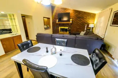 a table and chairs in a living room with a couch at Great Price, Great Location in Canton
