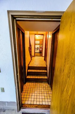 a hallway with stairs leading to a room with a kitchen at Great Price, Great Location in Canton