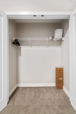 an empty room with white walls and a shelf at CozySuites at Textile in Cincinnati