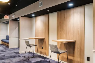a waiting room with two chairs and wooden panels at CozySuites at Textile in Cincinnati