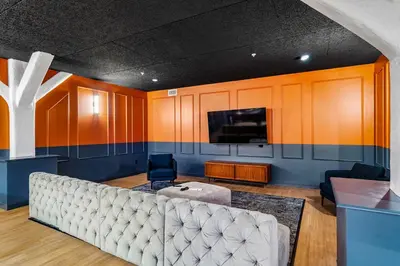 a living room with a couch and a tv at CozySuites at Textile in Cincinnati