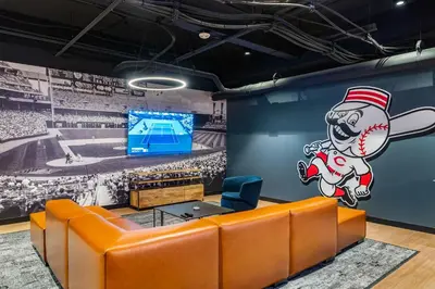 a room with a baseball game mural on the wall at CozySuites at Textile in Cincinnati