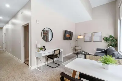 a living room with a couch and a table at CozySuites at Textile in Cincinnati