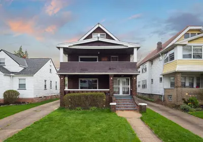 a large white house with a lawn in front of it at RocknRoll Crib 8 Min Cle Clinic Near Downtown in Cleveland