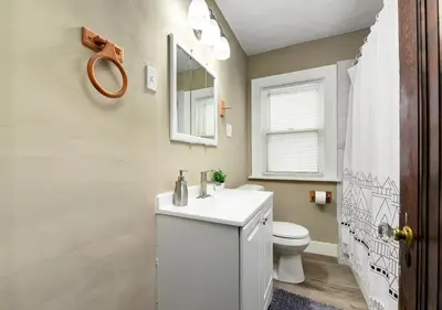 a bathroom with a white sink and a toilet at RocknRoll Crib 8 Min Cle Clinic Near Downtown in Cleveland