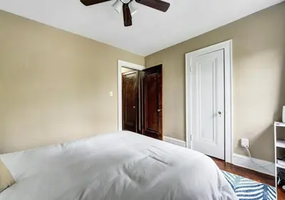 a bedroom with a white bed and a ceiling fan at RocknRoll Crib 8 Min Cle Clinic Near Downtown in Cleveland