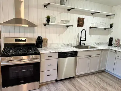 a kitchen with a stove and a sink at 4 Bed Ranch-Fire Pit-Pet & Kid Friendly-King Bed-Arcade in Columbus