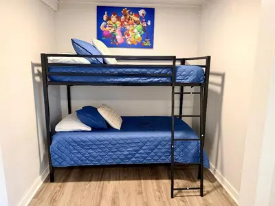 a couple of bunk beds in a room at 4 Bed Ranch-Fire Pit-Pet & Kid Friendly-King Bed-Arcade in Columbus