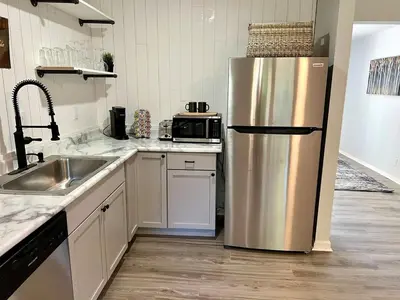 a kitchen with a stainless steel refrigerator and a sink at 4 Bed Ranch-Fire Pit-Pet & Kid Friendly-King Bed-Arcade in Columbus