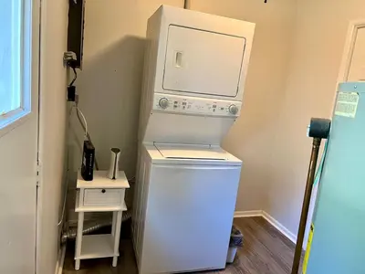 a washer and dryer in a corner of a room at 4 Bed Ranch-Fire Pit-Pet & Kid Friendly-King Bed-Arcade in Columbus