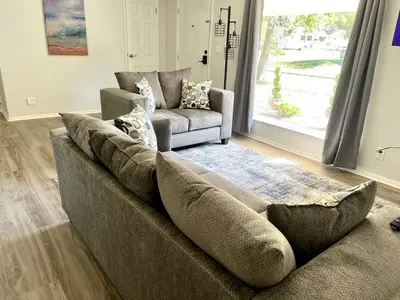 a living room with a couch and a chair at 4 Bed Ranch-Fire Pit-Pet & Kid Friendly-King Bed-Arcade in Columbus