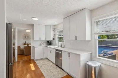 a white kitchen with a sink and a refrigerator at Ultimate Group Escape Heated Pool - 12 Guests in Parma
