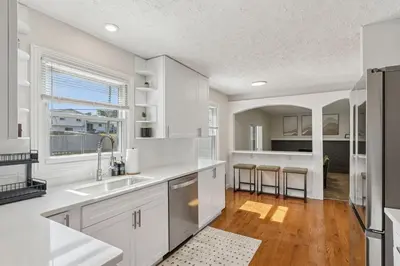 a kitchen with white cabinets and a large window at Ultimate Group Escape Heated Pool - 12 Guests in Parma