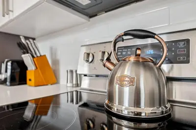 a tea kettle sitting on a stove in a kitchen at Ultimate Group Escape Heated Pool - 12 Guests in Parma