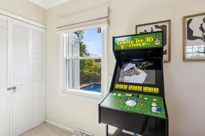 a video game machine in a room next to a window at Ultimate Group Escape Heated Pool - 12 Guests in Parma